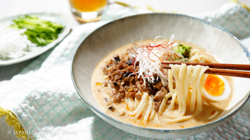 Cold tantanmen udon with creamy sesame soup, spicy ground pork, and a soft-boiled egg