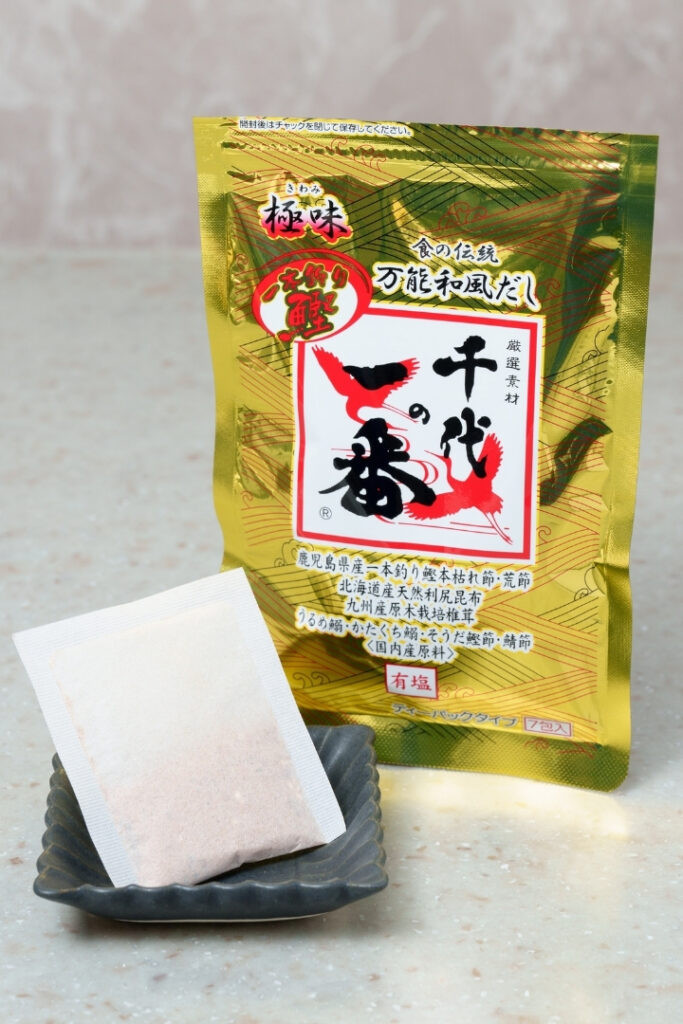 Dashi packet and package displayed on a small plate.