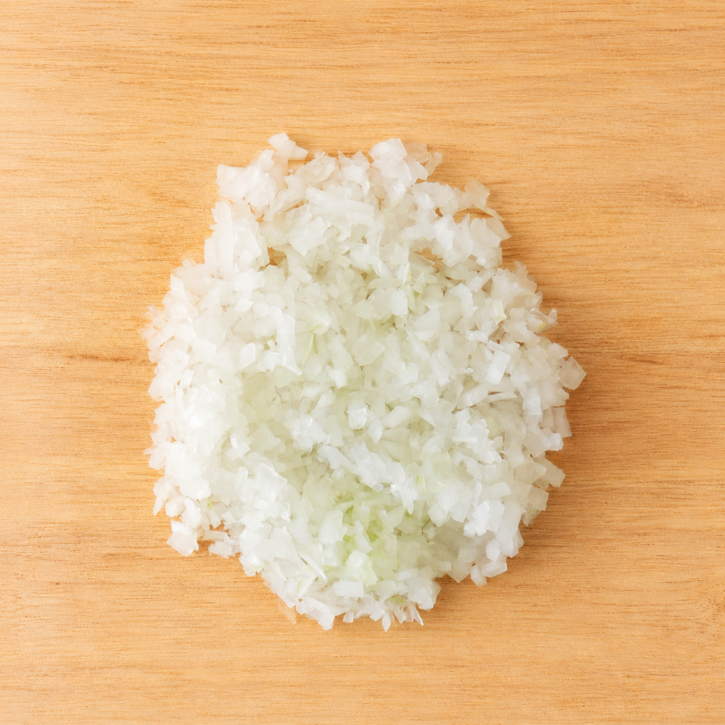Finely minced onion on a wooden cutting board