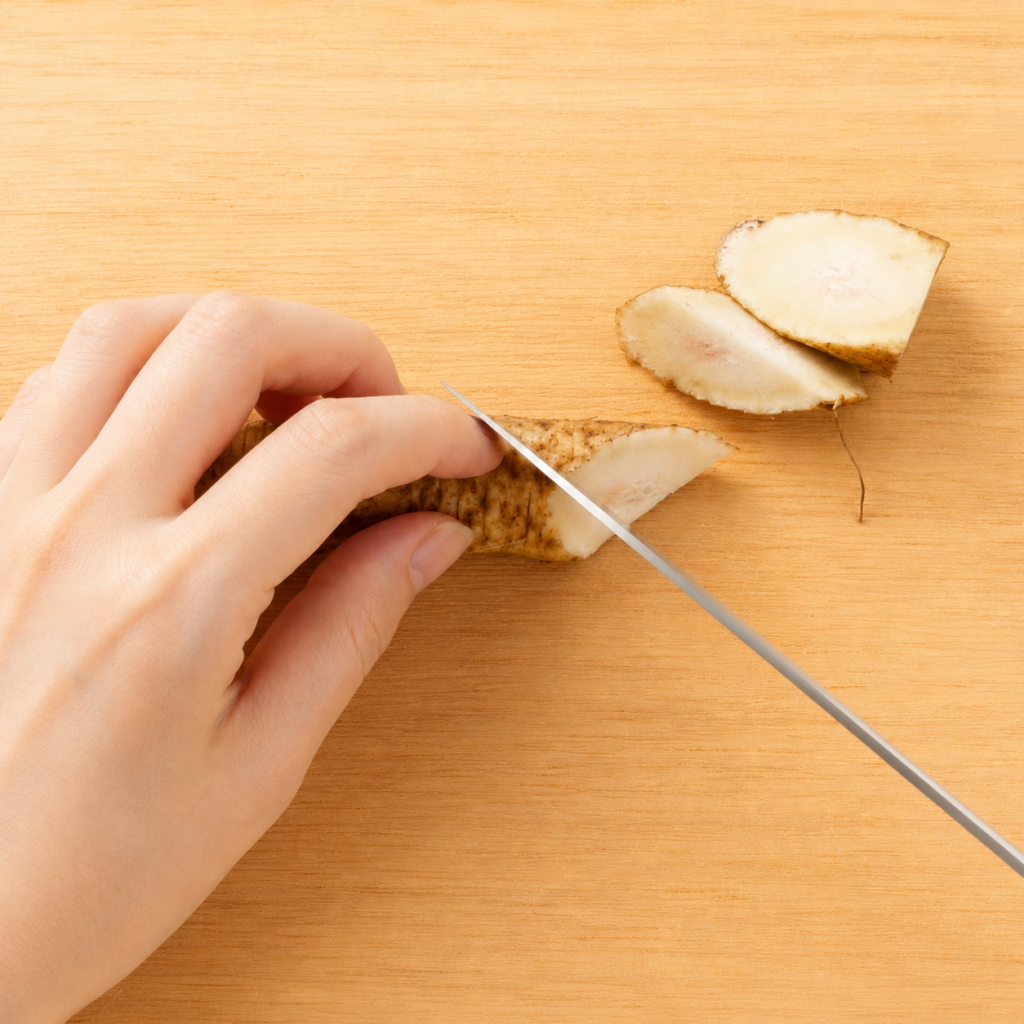 Burdock root being rotated and cut diagonally using the rangiri technique