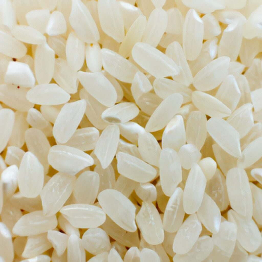Close-up photo of uncooked white rice grains.