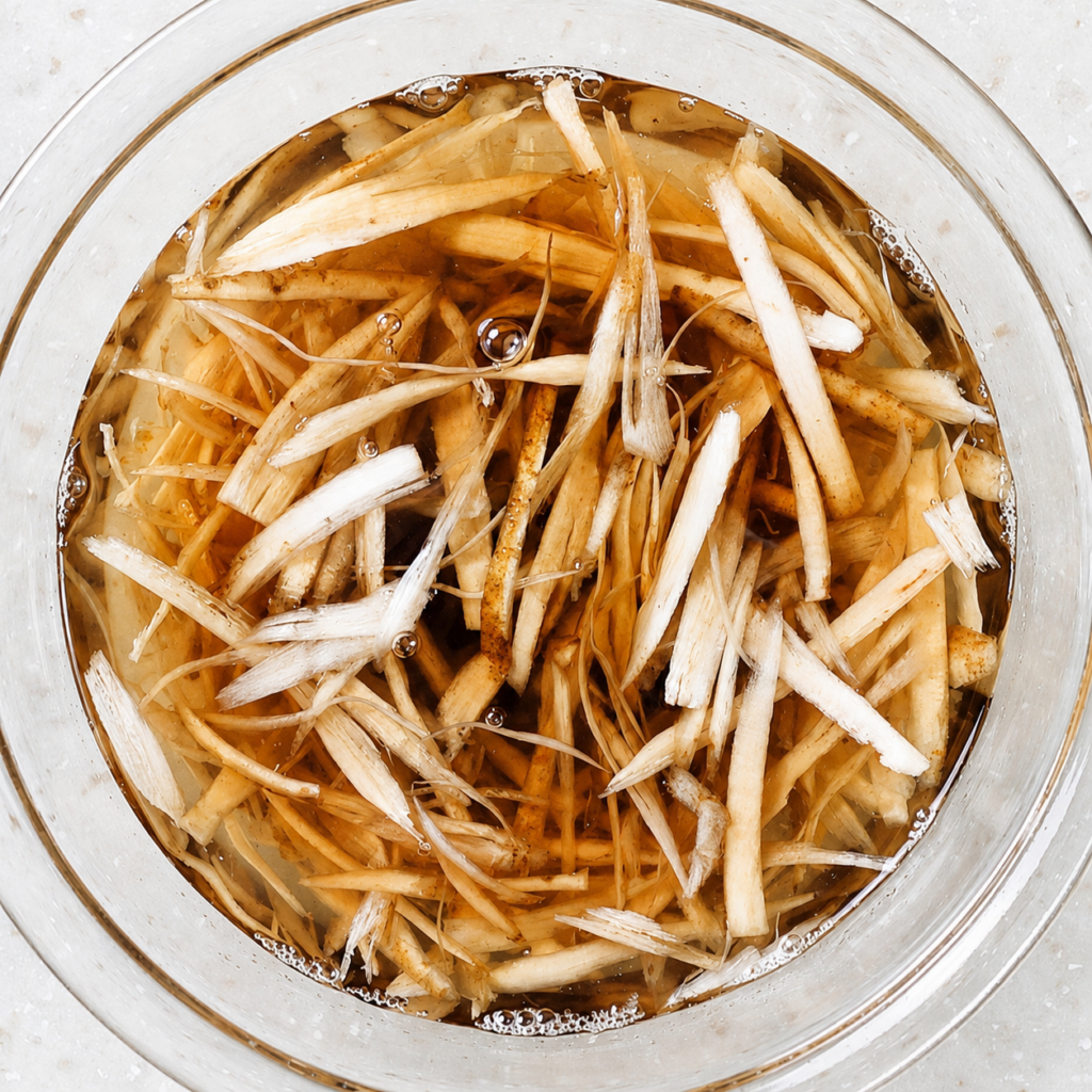 Sasagaki-cut gobo soaking in a bowl of water