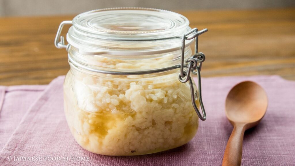 Homemade shio koji in a glass jar on a pink cloth