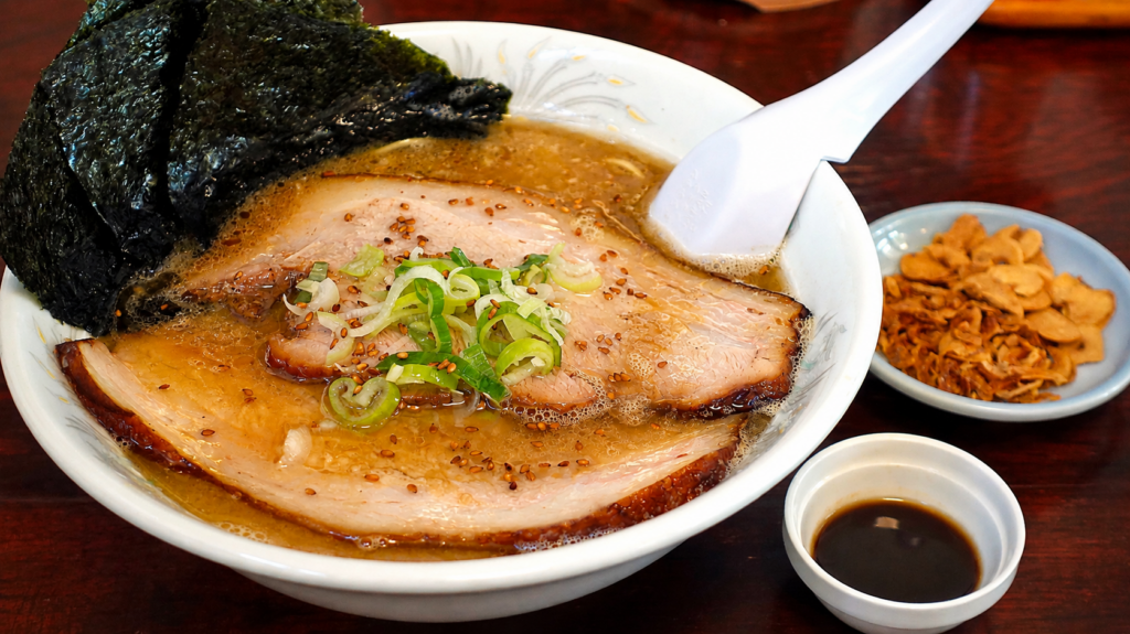 Ore no Kunsei Shoyu Ramen at Satsuki in Kamikawa, Hokkaido, topped with large slices of chashu pork, green onions, sesame seeds, and nori.
