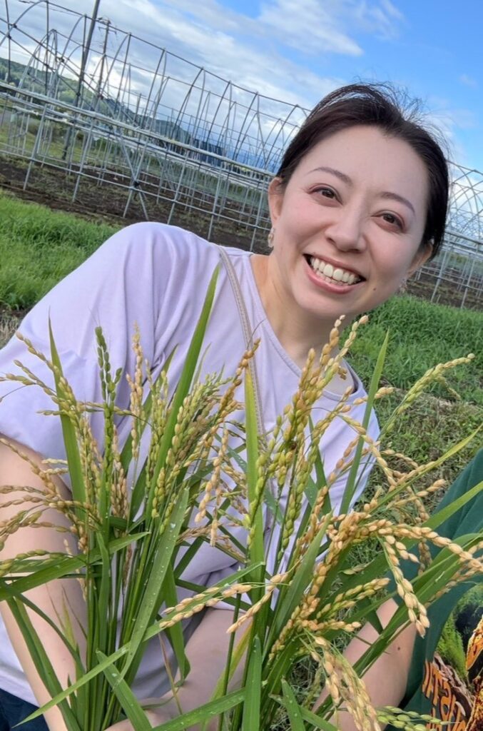 Chef Reina holding mochi rice plants in Kamikawa, Hokkaido