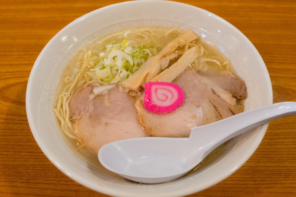 Shio ramen at Nidaime Tetsujin Takahashi in Kamikawa, Hokkaido, topped with chashu pork, menma, narutomaki, and Japanese leek.