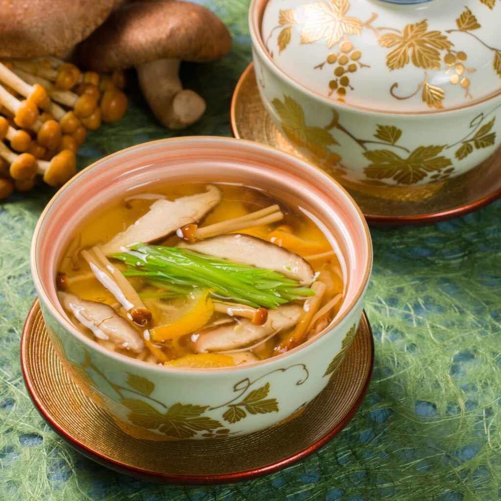 Japanese chawanmushi topped with a savory mushroom ankake sauce, served in an elegant ceramic cup.
