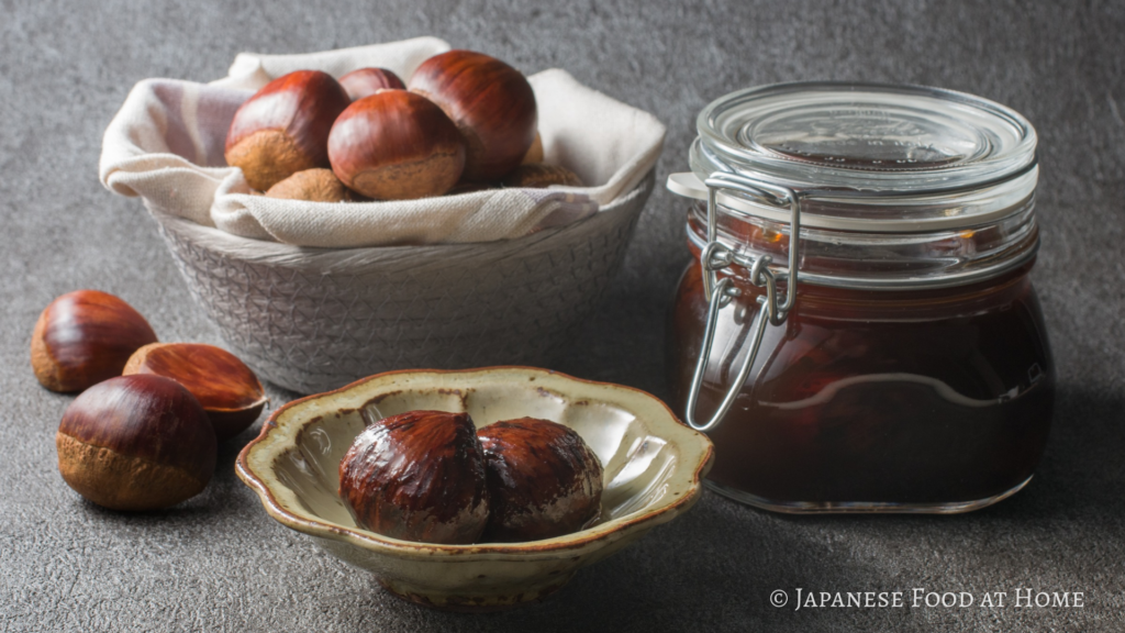 Japanese shibukawa-ni candied chestnuts served on a plate with fresh chestnuts and a jar of syrup